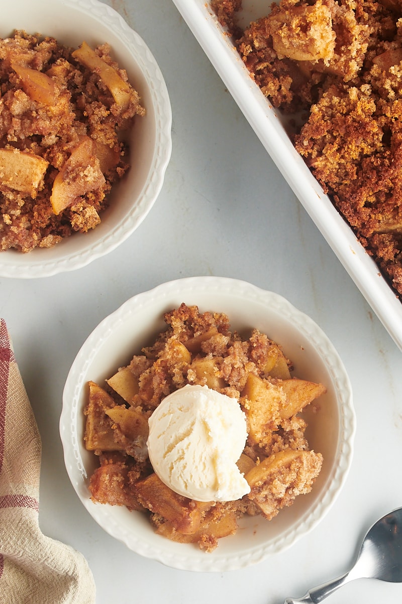 Overhead view of Apple Brown Betty in two bowls and baking dish