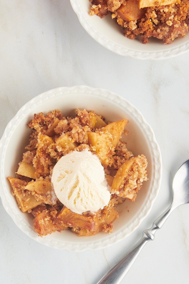 Overhead view of Apple Brown Betty in bowl with ice cream on top