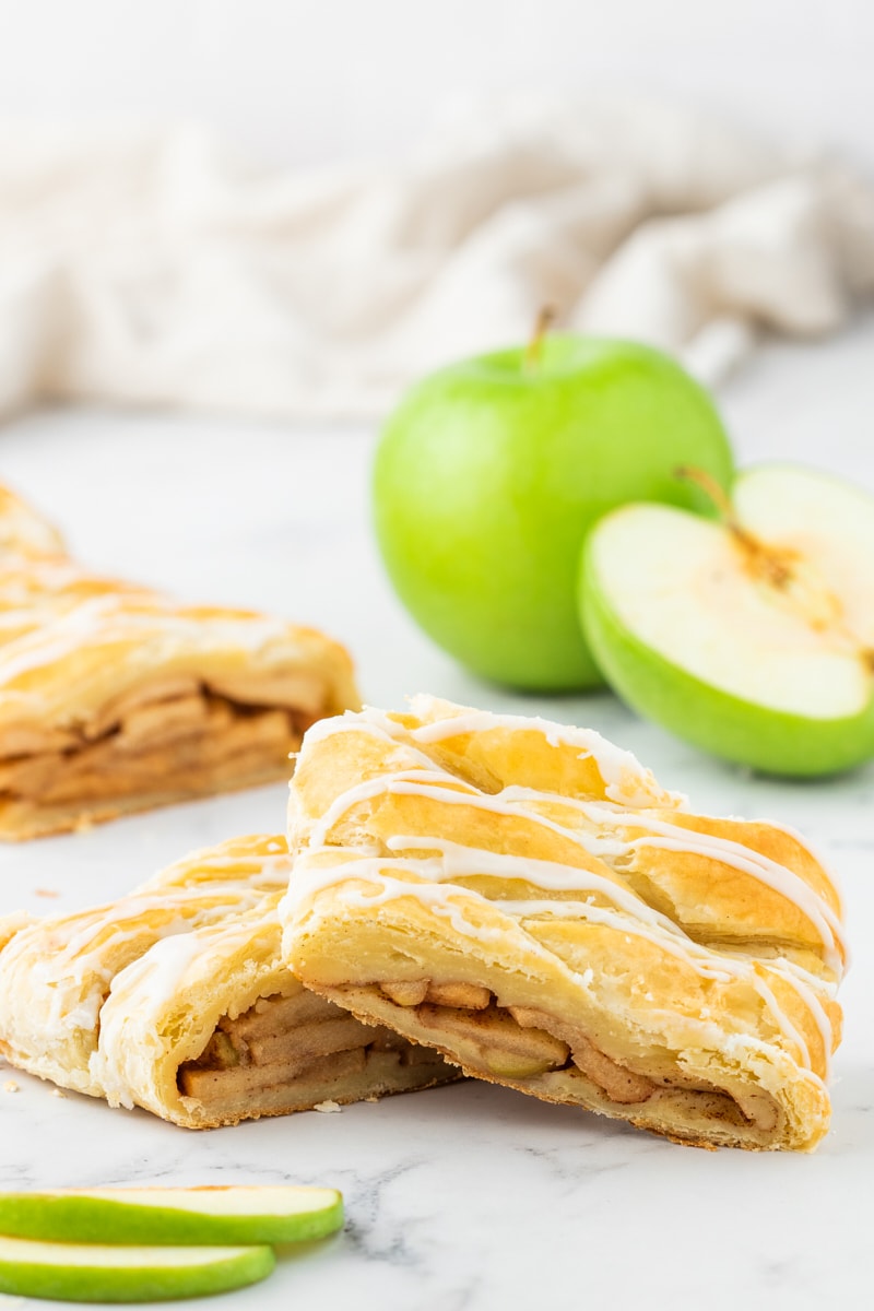 two slices of apple strudel on a marble surface