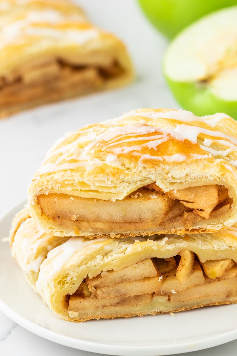 two slices of apple strudel stacked on a white plate