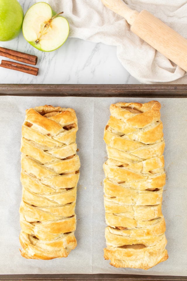 overhead view of freshly baked apple strudel on a baking sheet
