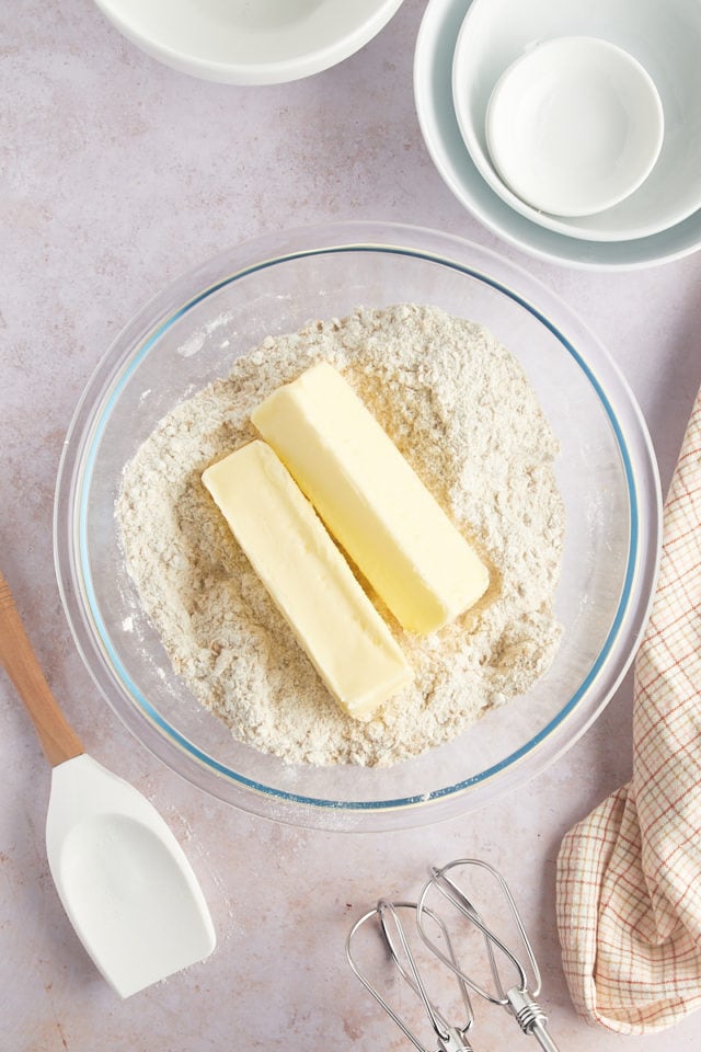 Overhead view of butter in bowl with dry ingredients