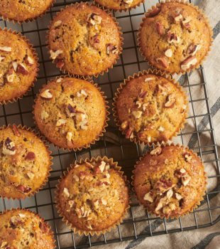 overhead view of date nut muffins on a wire rack