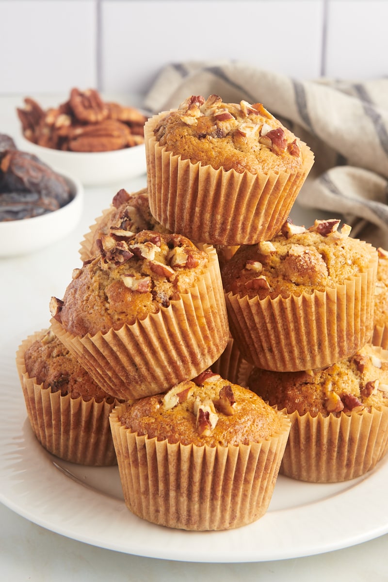 date nut muffins piled on a white plate