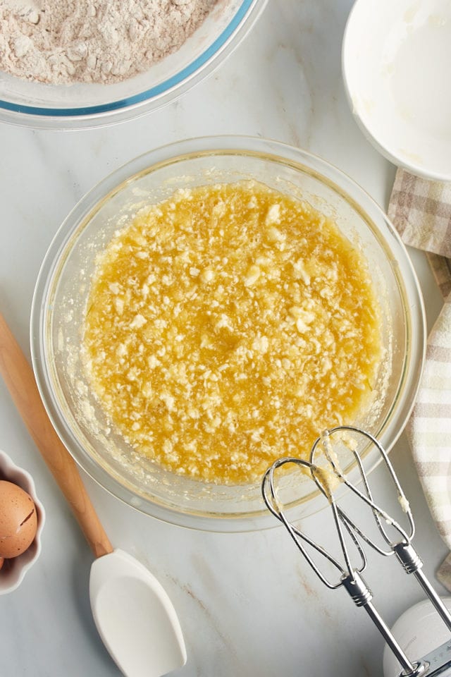 Overhead view of wet ingredients in glass mixing bowl