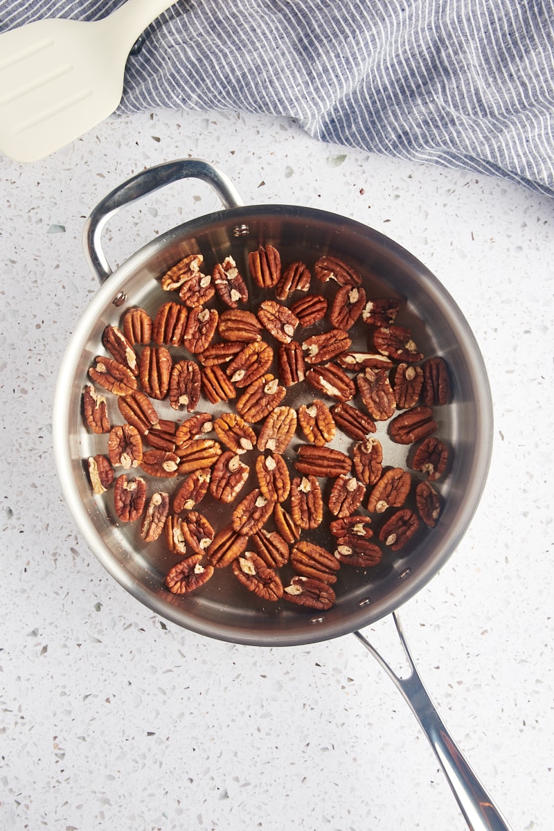 overhead view of toasted pecans in a skillet