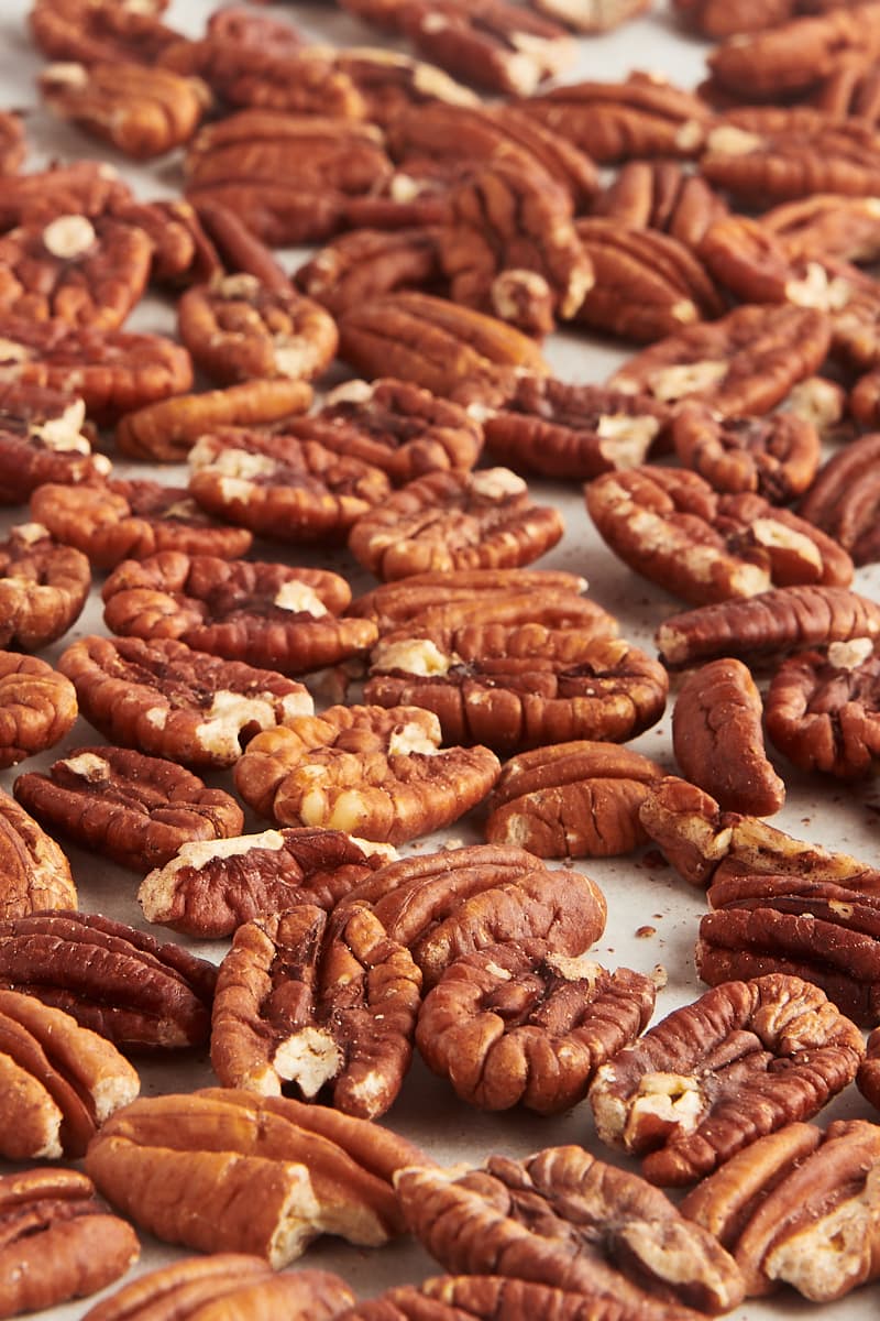 toasted pecans scattered on parchment paper