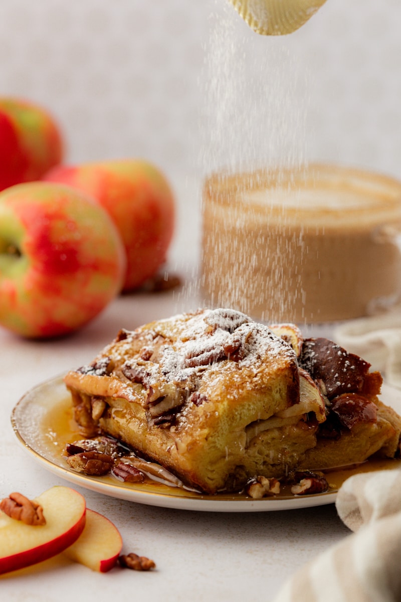 Dusting powdered sugar on piece of apple cinnamon French toast