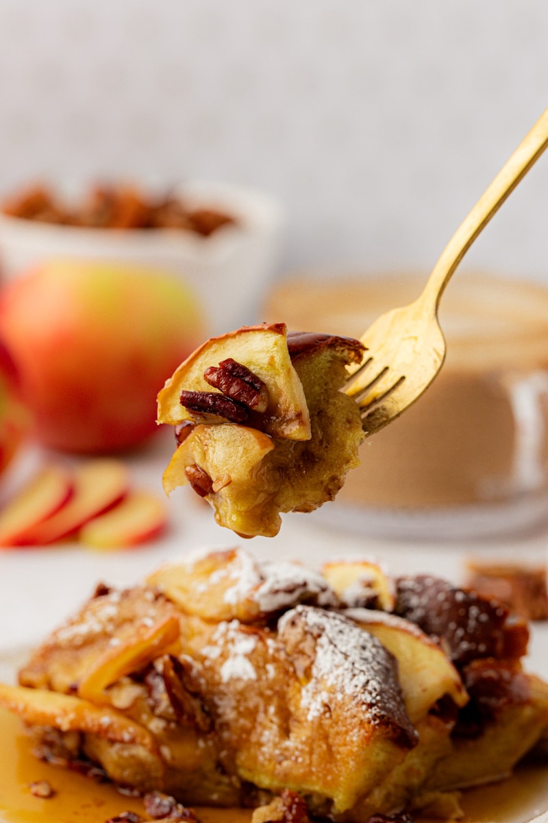 Forkful of apple cinnamon French toast held over plate