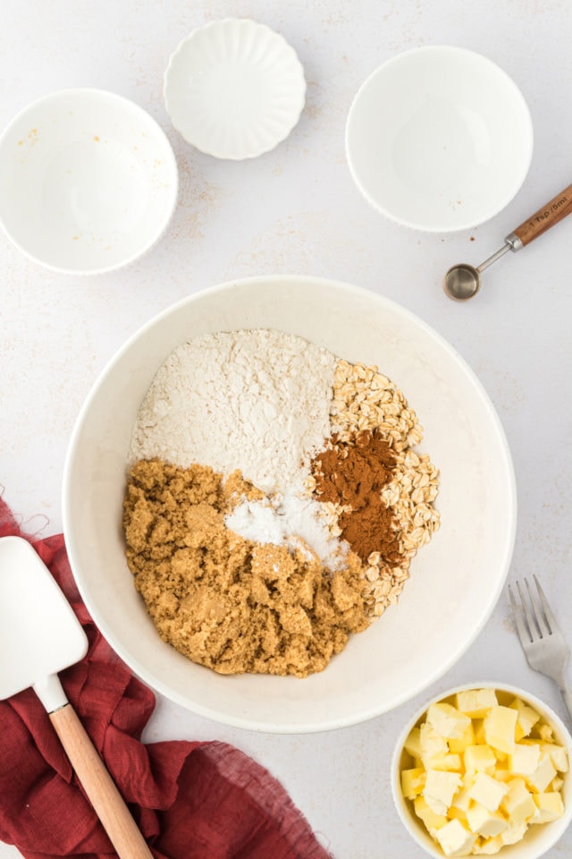 Overhead view of dry ingredients for crust in mixing bowl before stirring