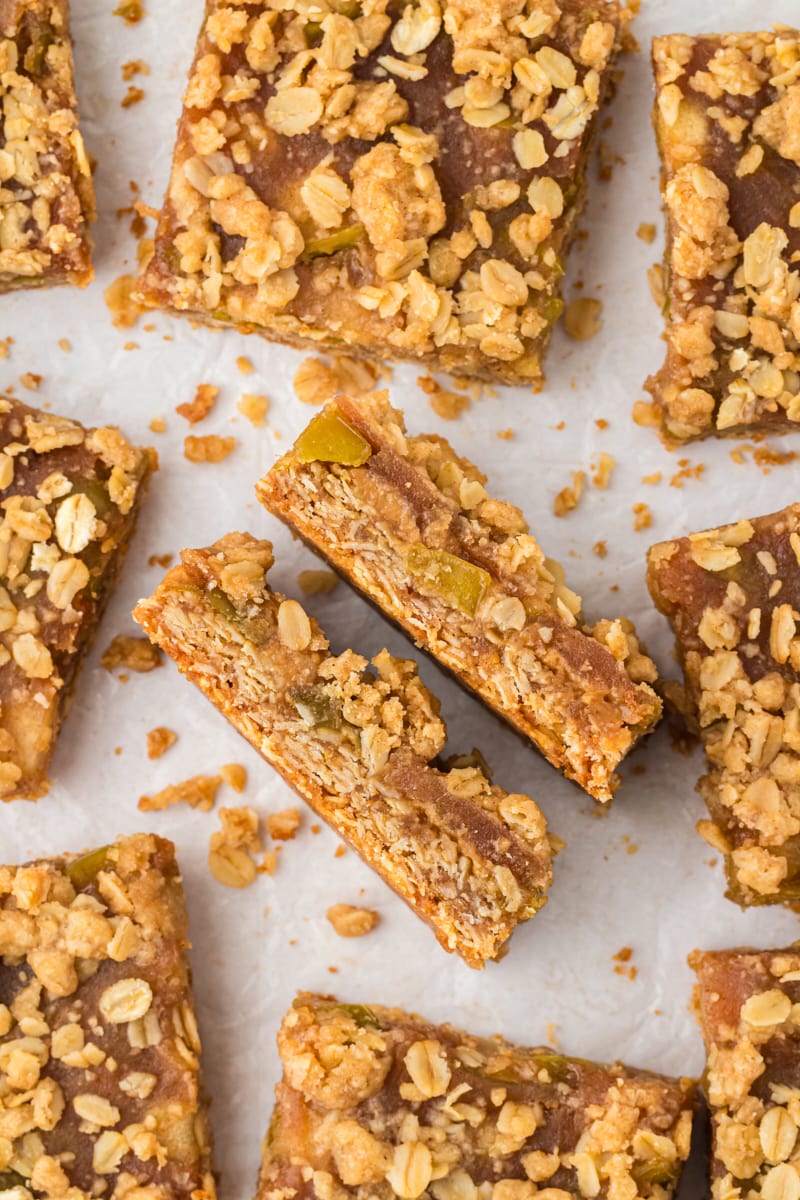 Overhead view of caramel apple bars on parchment paper with two bars sideways to show layers