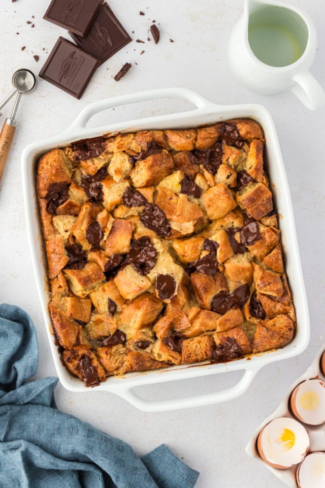 Overhead view of chocolate croissant bread pudding in white square baking dish