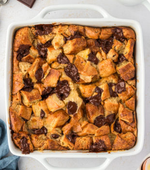 Overhead view of chocolate croissant bread pudding in square baking dish