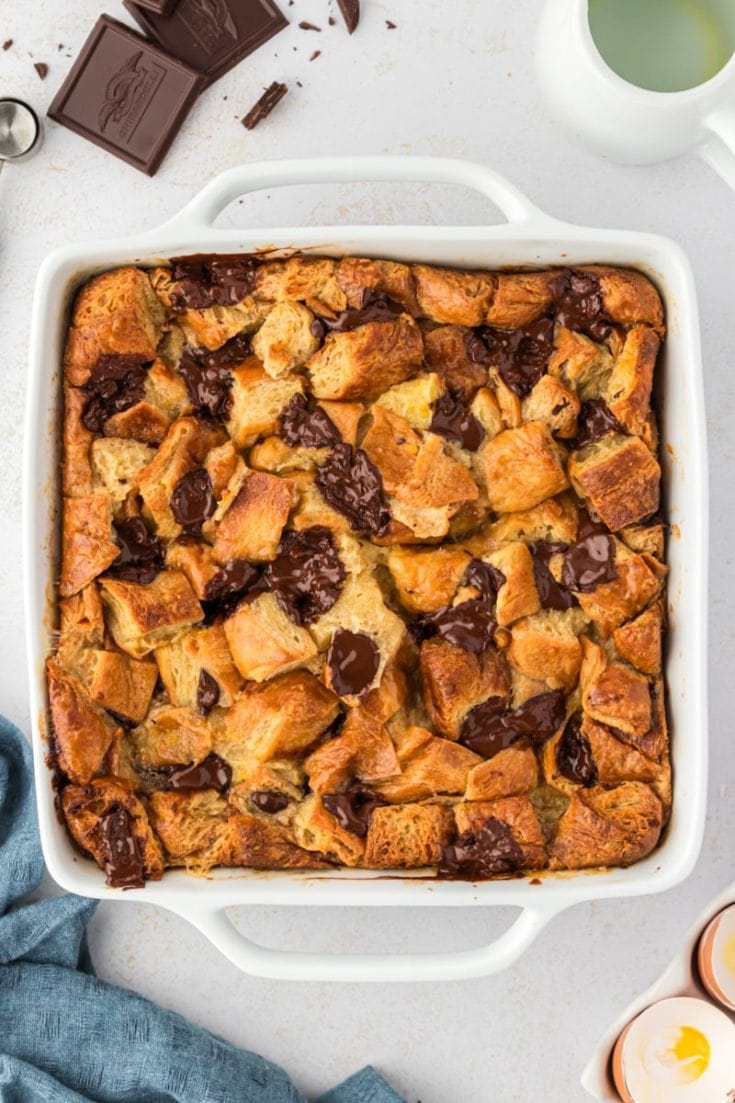 Overhead view of chocolate croissant bread pudding in square baking dish