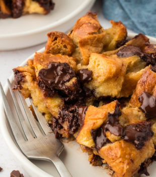 Closeup of chocolate croissant bread pudding on plate with fork
