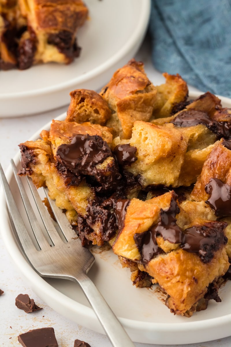 Closeup of chocolate croissant bread pudding on plate with fork