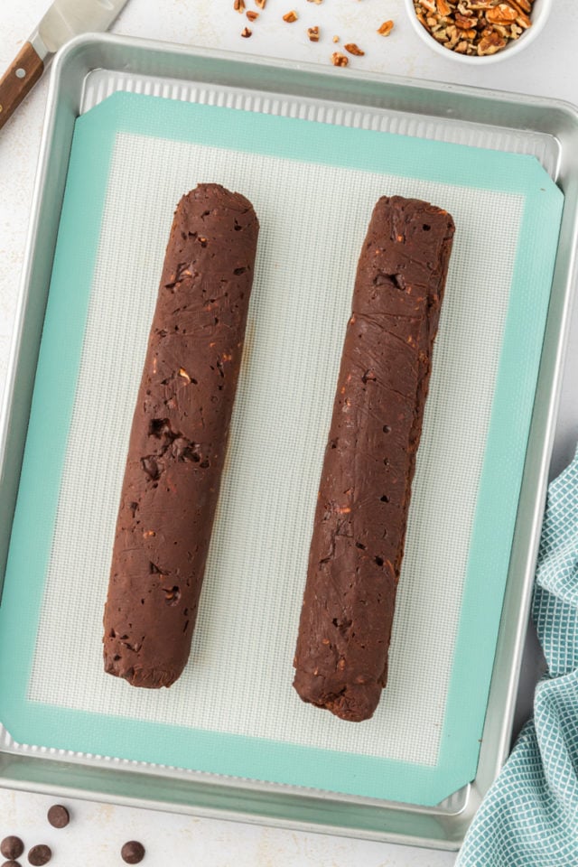 Overhead view of double chocolate cookie dough logs on baking sheet