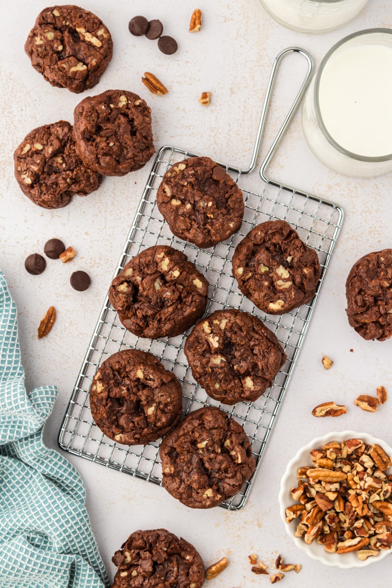 Overhead view of double chocolate cookies on wire rack and countertop