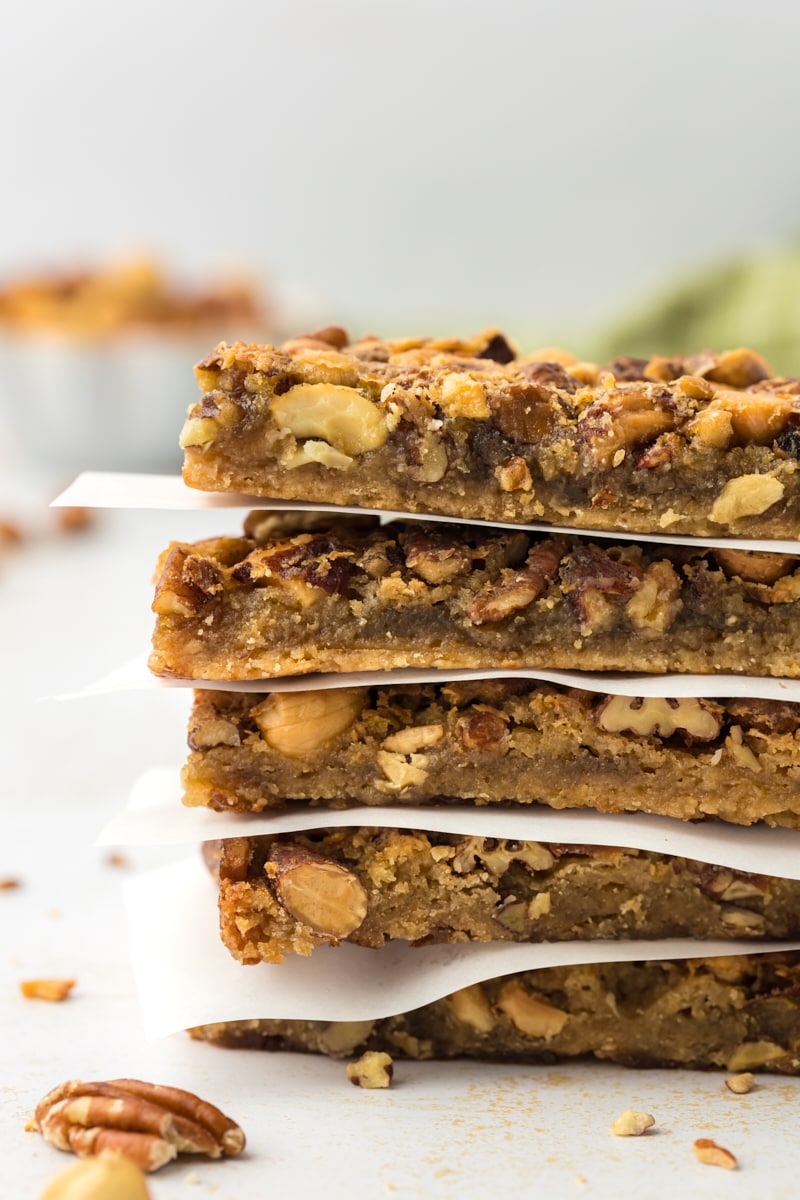 Stack of maple nut bars with parchment paper between layers