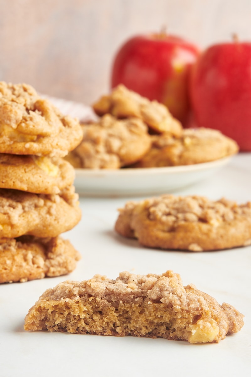 A partial crumb-topped apple cookie with more cookies in the background.