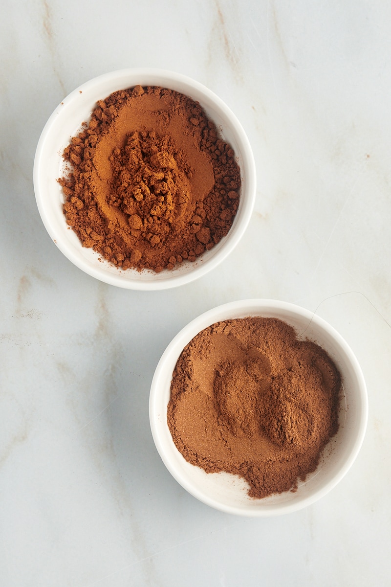 overhead view of ground cinnamon in two shallow white bowls