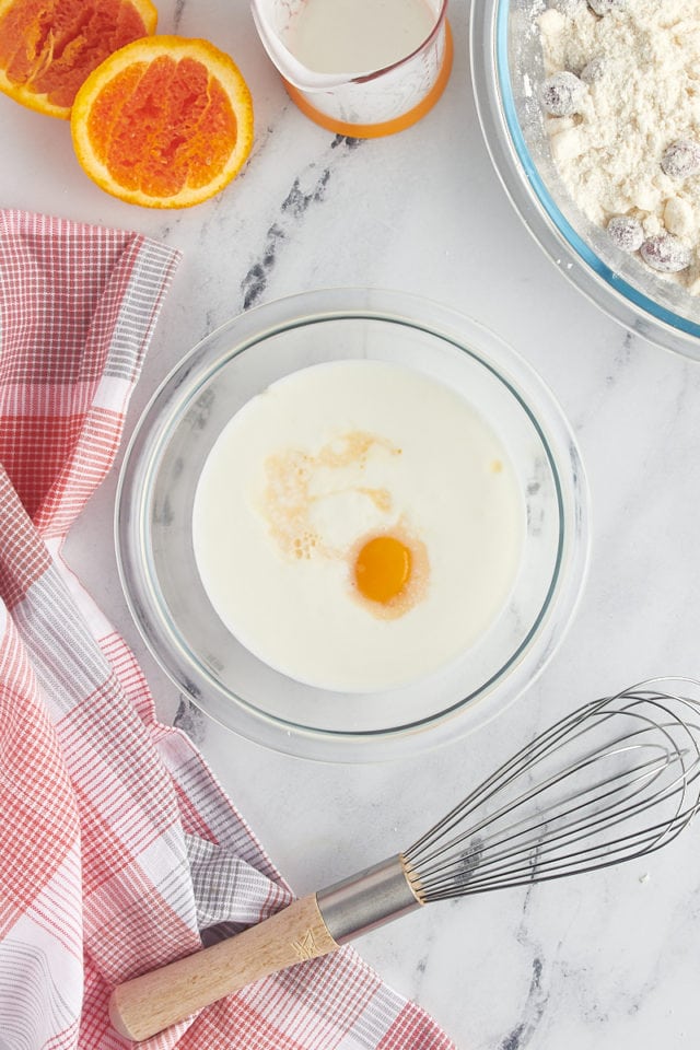 overhead view of buttermilk, egg yolk, and orange juice in a small glass bowl