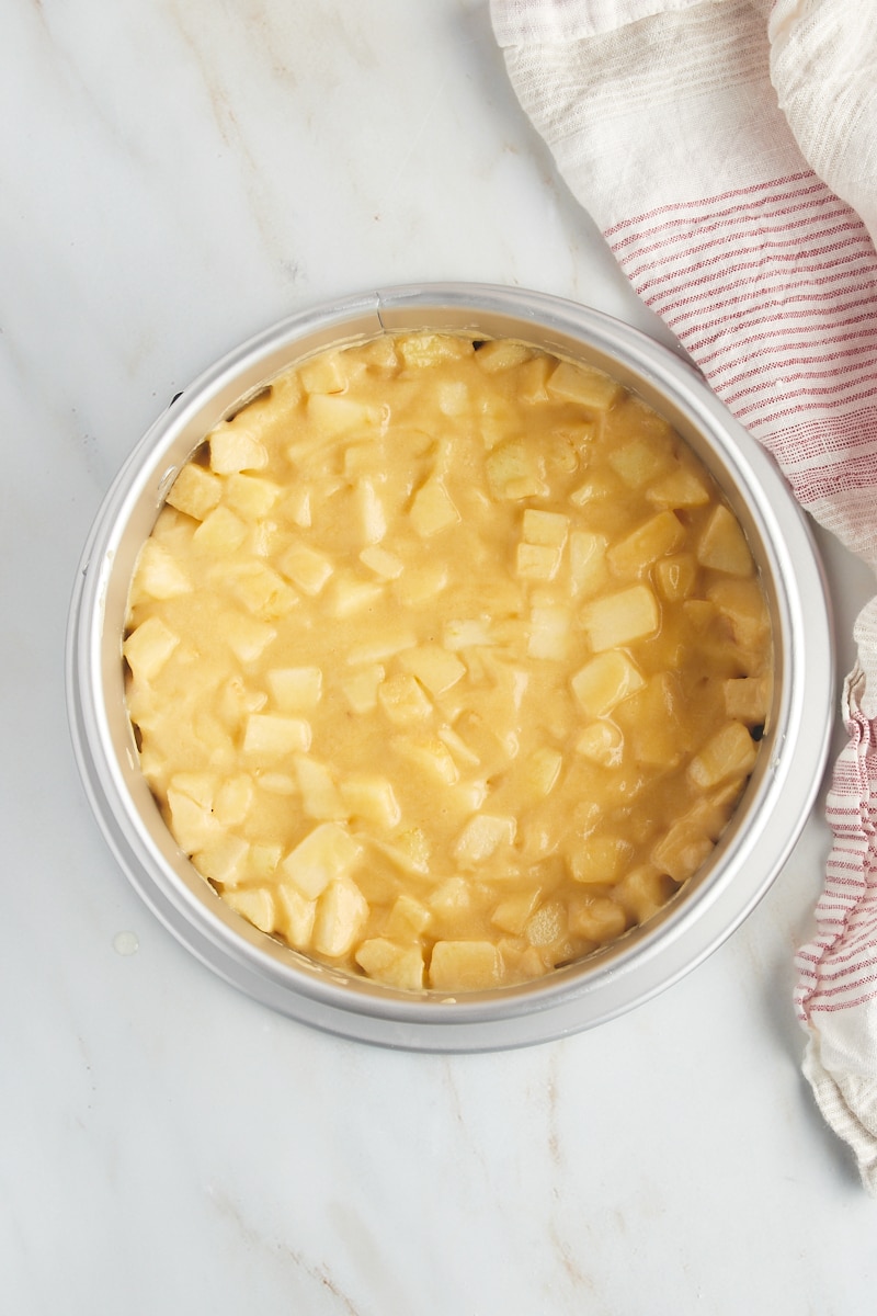 overhead view of French apple cake batter in a springform pan