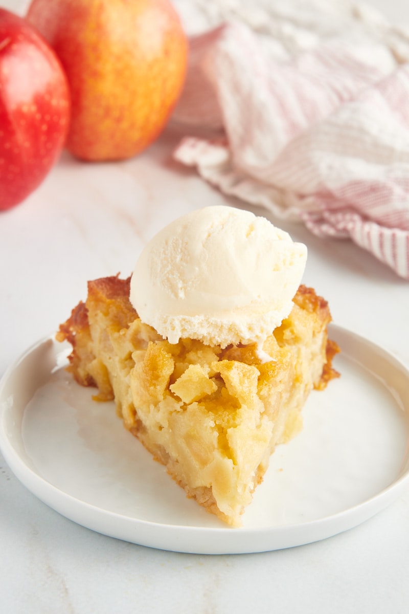 a slice of French apple cake topped with ice cream