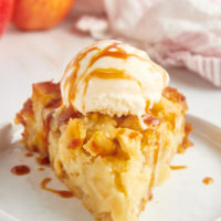 a slice of French apple cake topped with ice cream and caramel sauce