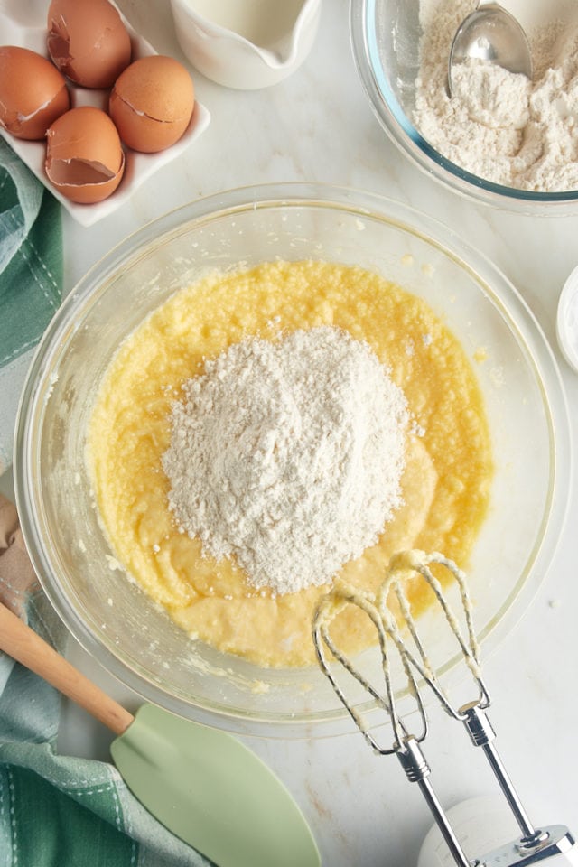 overhead view of dry ingredients added to cake batter