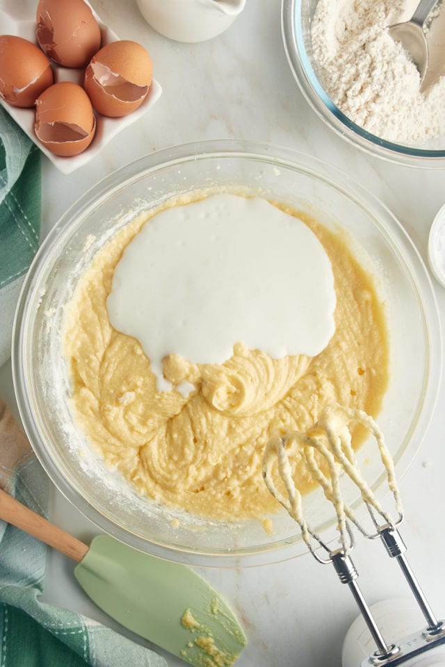 overhead view of buttermilk added to cake batter