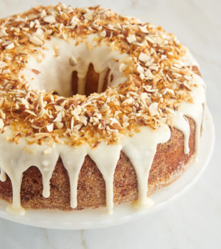 Louisiana Crunch Cake topped with a sweet glaze, toasted coconut, and chopped almonds