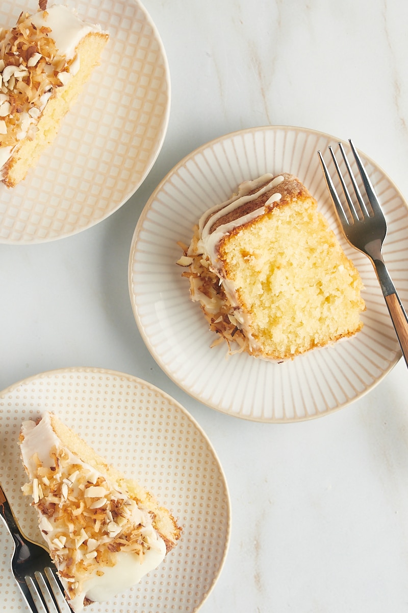 three slices of Louisiana Crunch Cake on white and beige plates