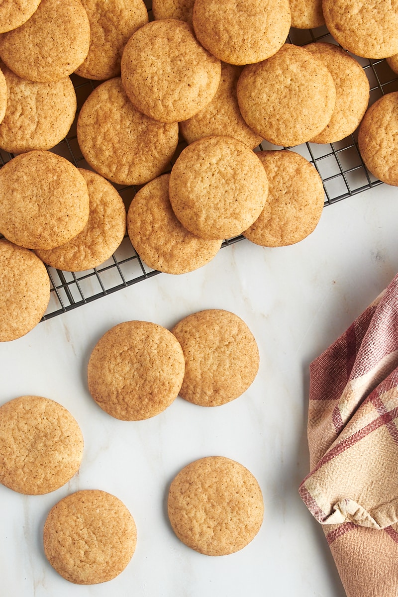 Overhead view of snickerdoodles on a wire rack and countertop.