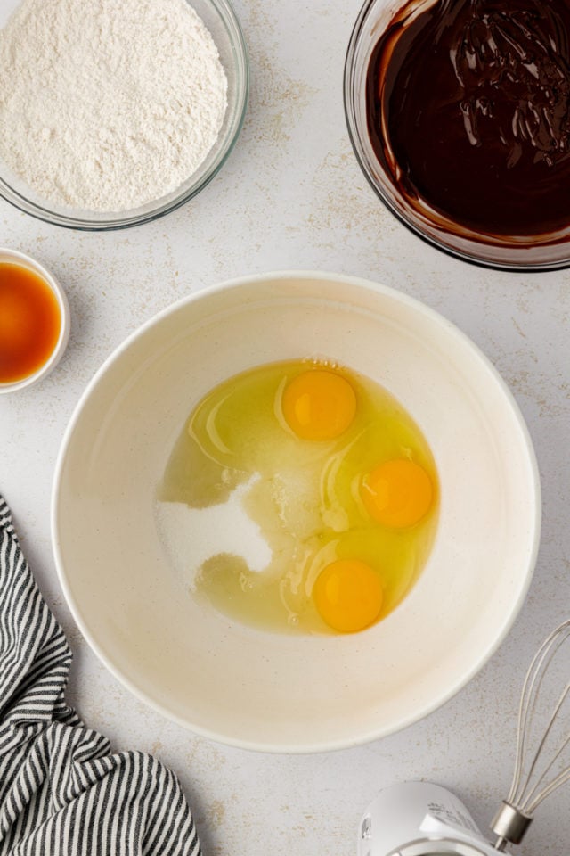 Overhead view of eggs and sugar in mixing bowl