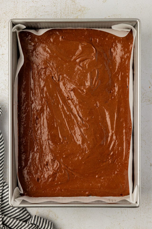 Overhead view of brownie layer in baking pan