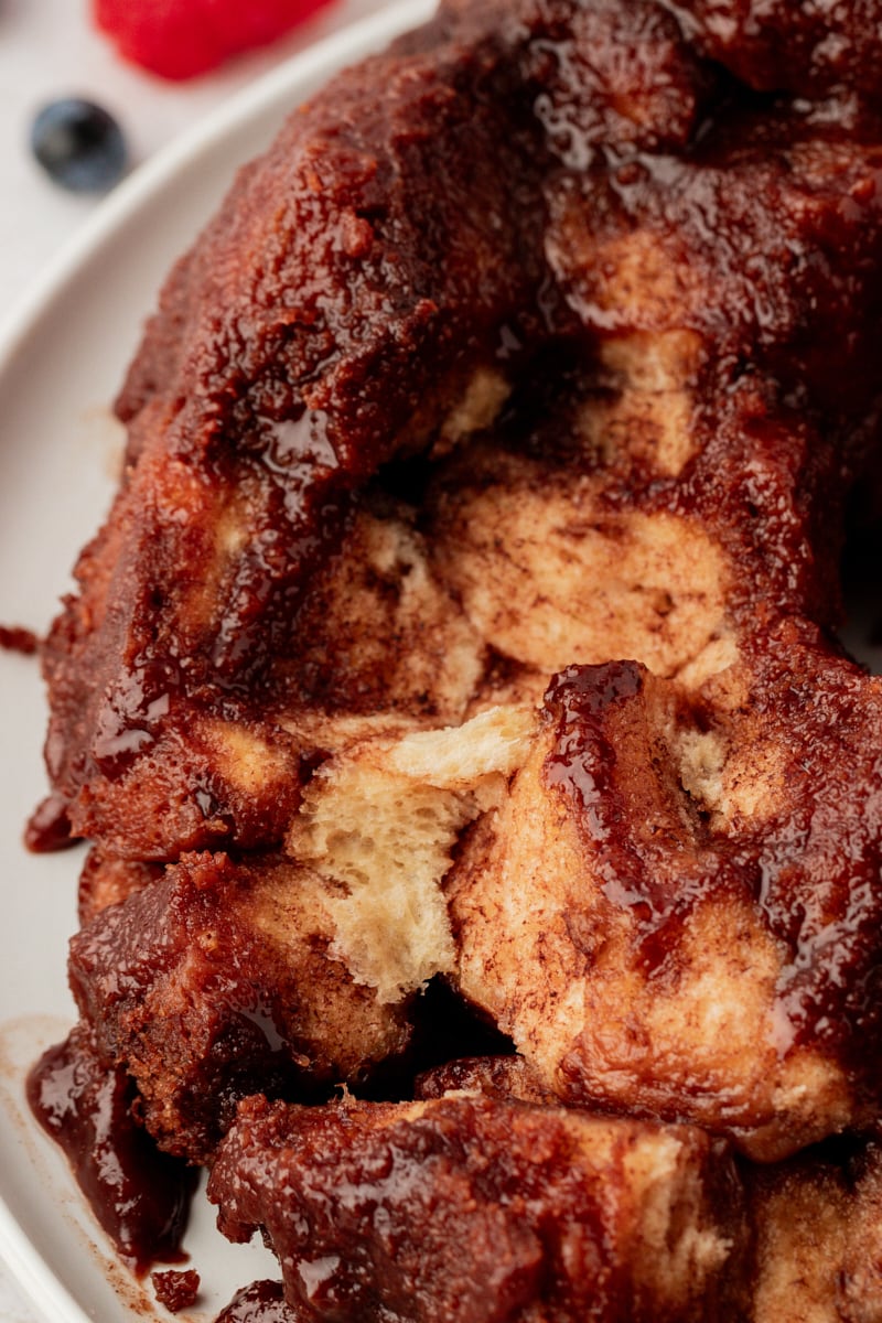 Chocolate monkey bread on platter with pieces removed