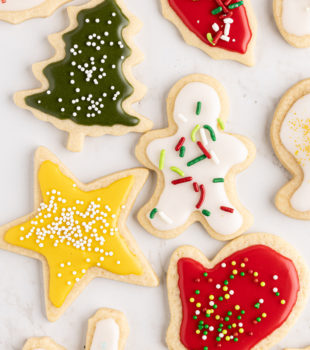 overhead view of decorated cut-out sugar cookies in various Christmas shapes