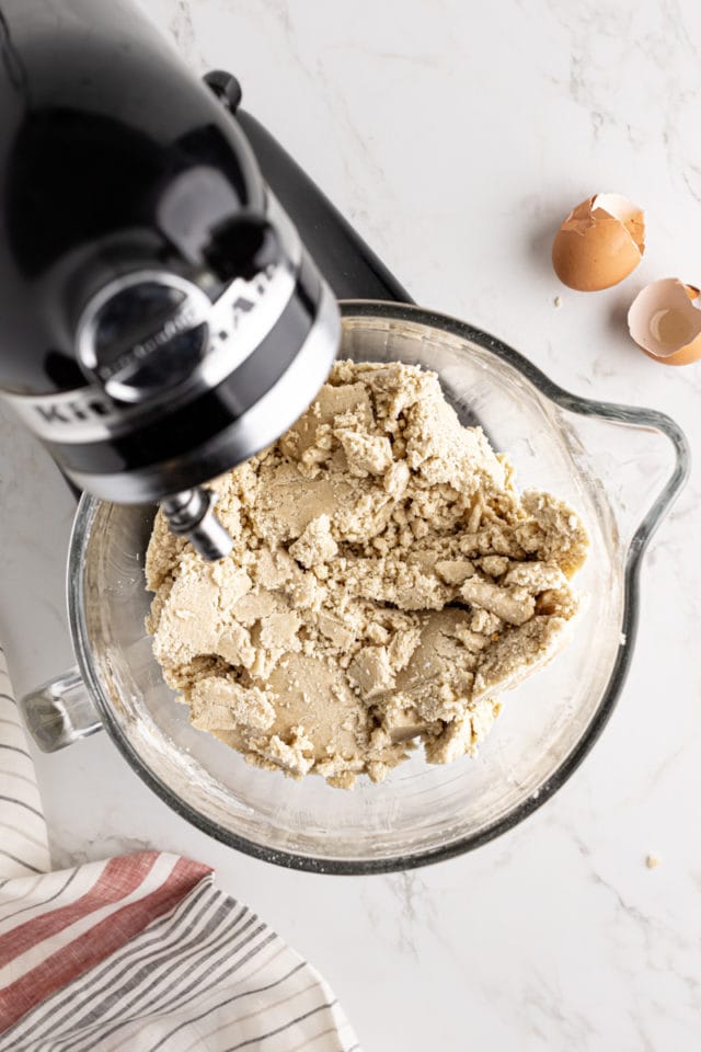 overhead view of mixed vanilla sugar cookie dough in the bowl of a stand mixer