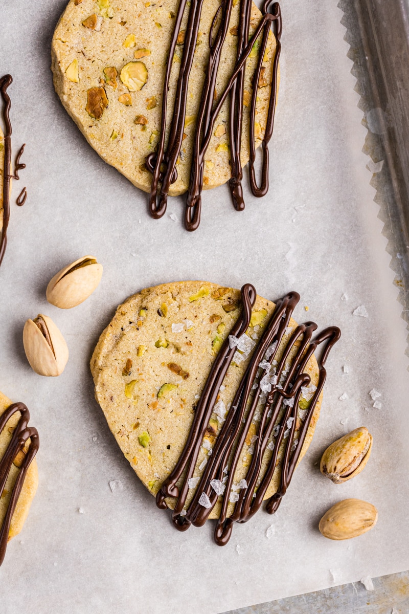 overhead view of pistachio cookies drizzled with melted dark chocolate