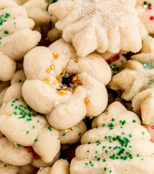 overhead view of lots of Christmas spritz cookies piled together