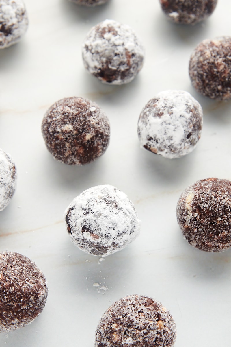 bourbon balls scattered on a marble countertop