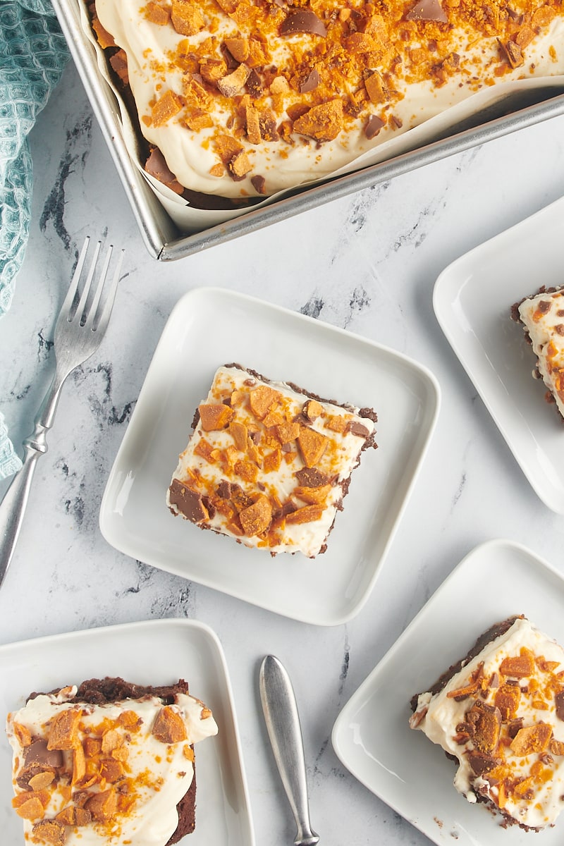 Overhead view of Butterfinger cake on plates and in pan