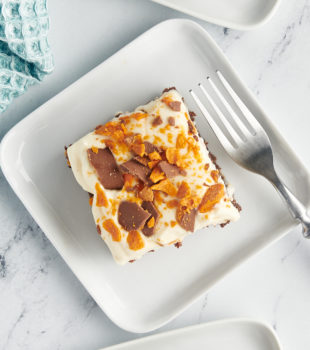 Overhead view of Butterfinger cake on plates with fork