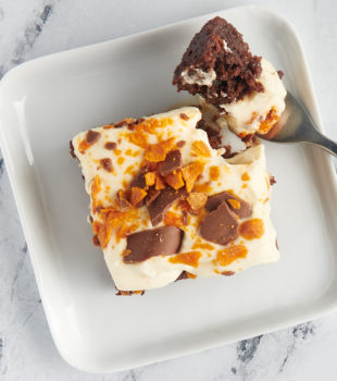 Overhead view of Butterfinger cake on plate with fork