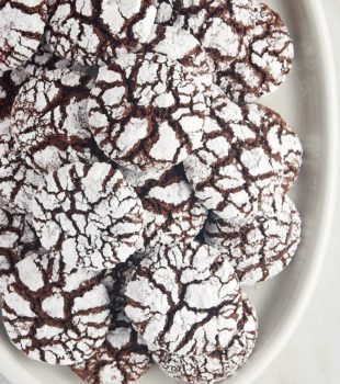 overhead view of chocolate crinkle cookies on a white serving tray