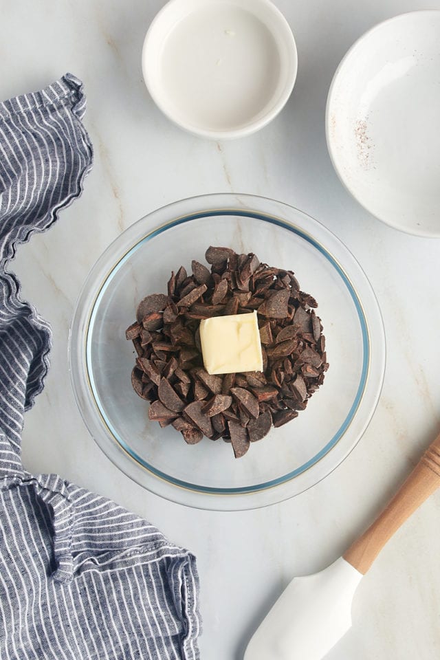 overhead view of chocolate and butter in a glass bowl