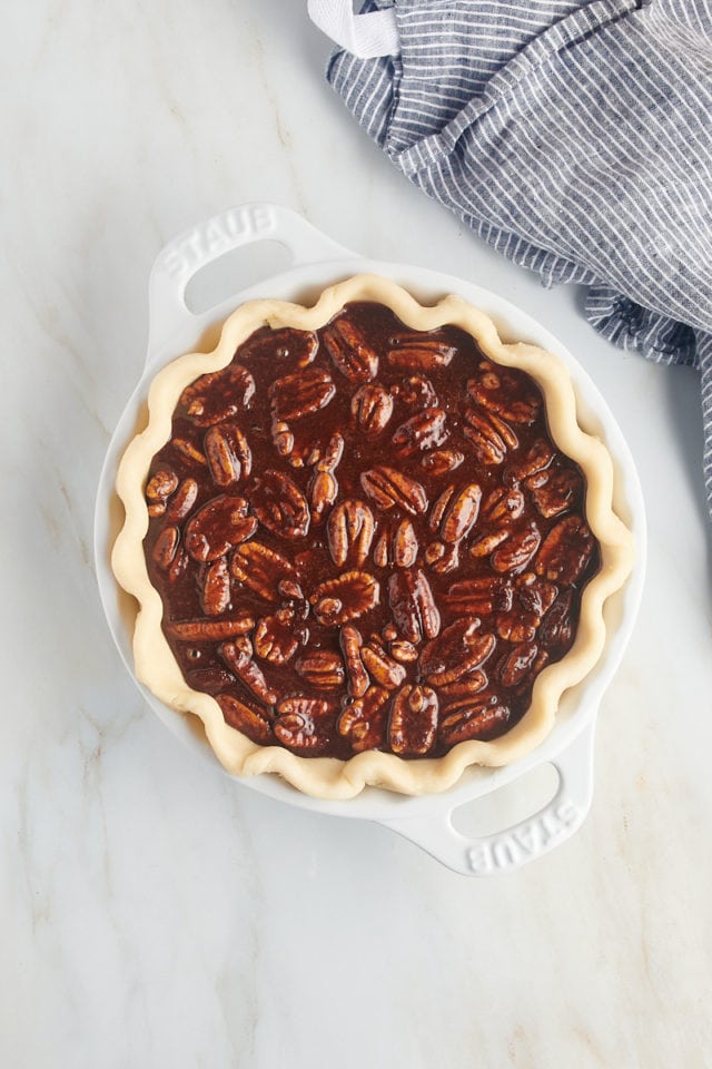 overhead view of chocolate pecan pie ready to go into the oven