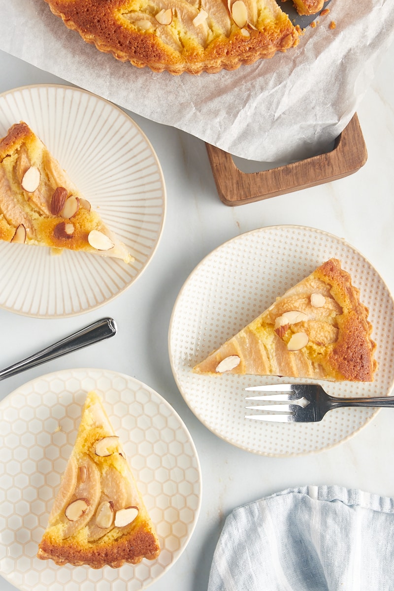 3 plates with slices of pear frangipane tart