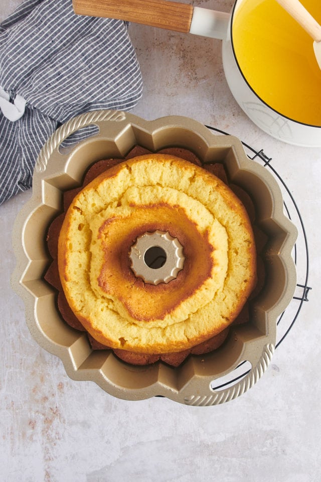Overhead view of rum cake in pan on wire rack